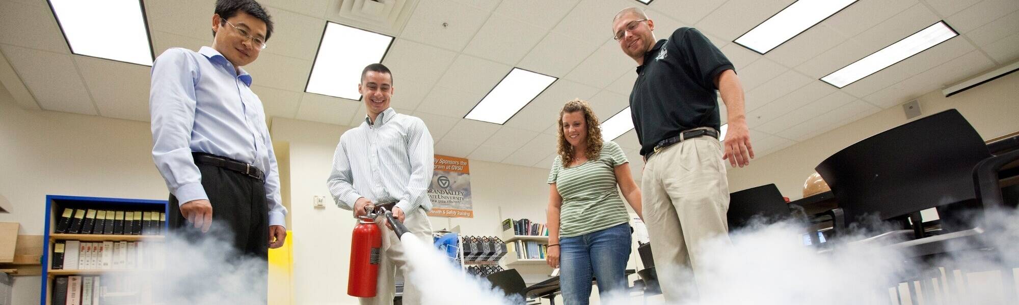 Occupational Safety and Health Management students putting out a fire